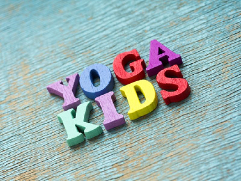 Yoga kids phrase made of wooden colorful letters on vintage background